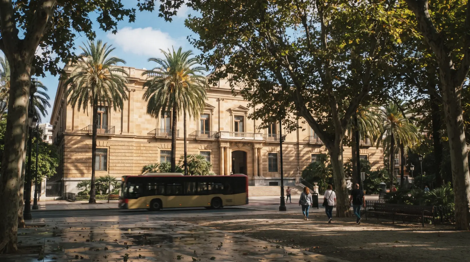 The neoclassical Palacio de la Aduana with its long stone façade seen from the Paseo del Parque in morning light, the Museo de Málaga