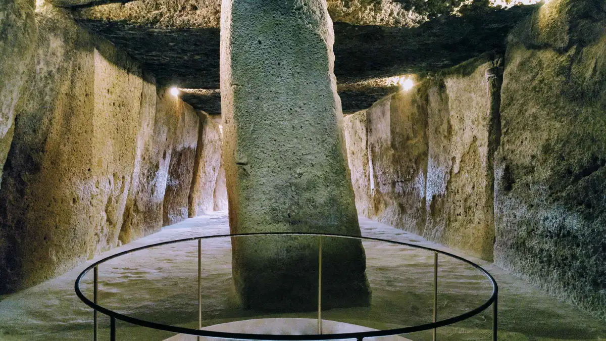Visitors inside the Tholos of El Romeral on a dolmens and El Torcal tour from Antequera near Málaga