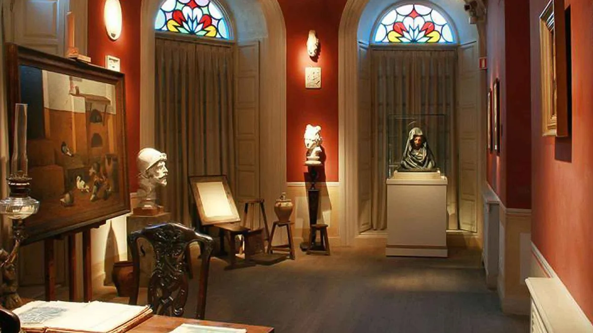 Guide showing family photographs in the rooms of Picasso's birthplace, guided tour of Casa Natal Picasso in Málaga