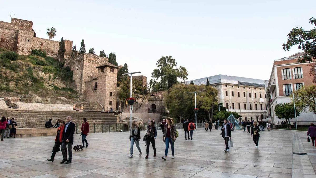 Small group with a guide on Calle Marqués de Larios, old town guided walking tour in Málaga