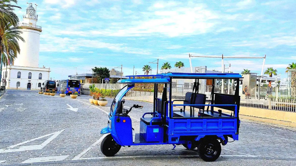 Electric tuk tuk parked at the Gibralfaro lookout above the bullring and port, tuk tuk sightseeing tour in Málaga