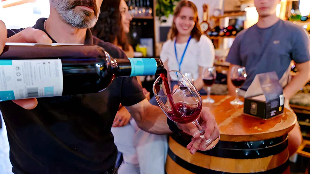 Tapas and glasses of Málaga wine on a bar counter with a rooftop view behind, wine and tapas tour with tastings and drinks in Málaga