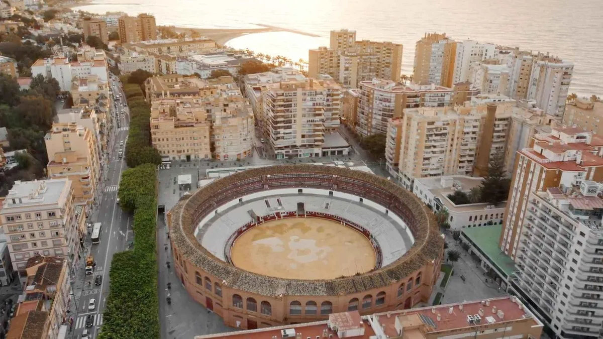 Empty sand ring and tiered seating inside the La Malagueta bullring on a guided tour in Malaga