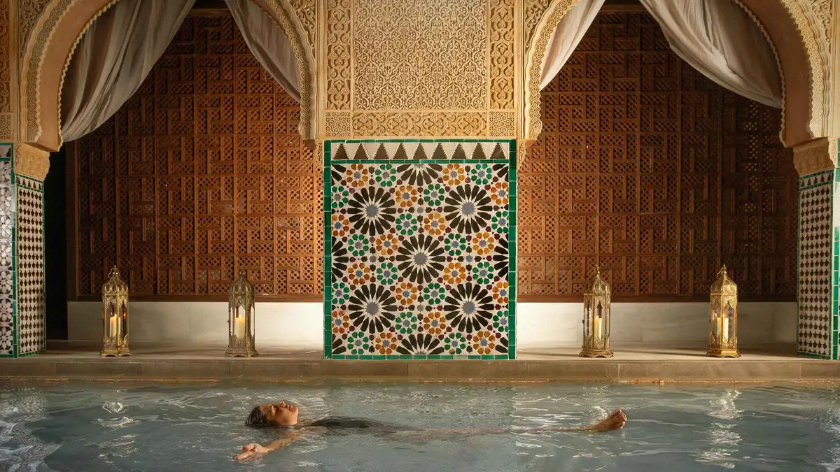 Visitors resting in the warm pool of the Arab baths at Hammam Al Andalus, Malaga