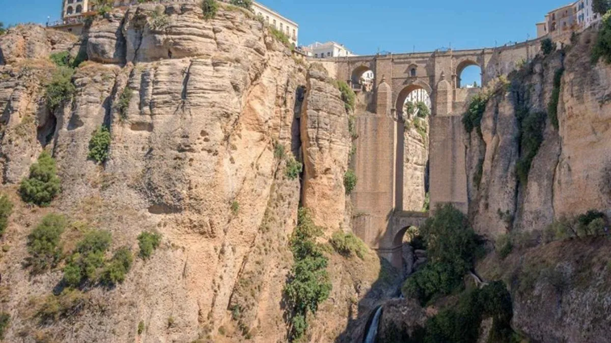 Cave houses built under the rock on Calle Cuevas del Sol in Setenil de las Bodegas, a day trip from Malaga