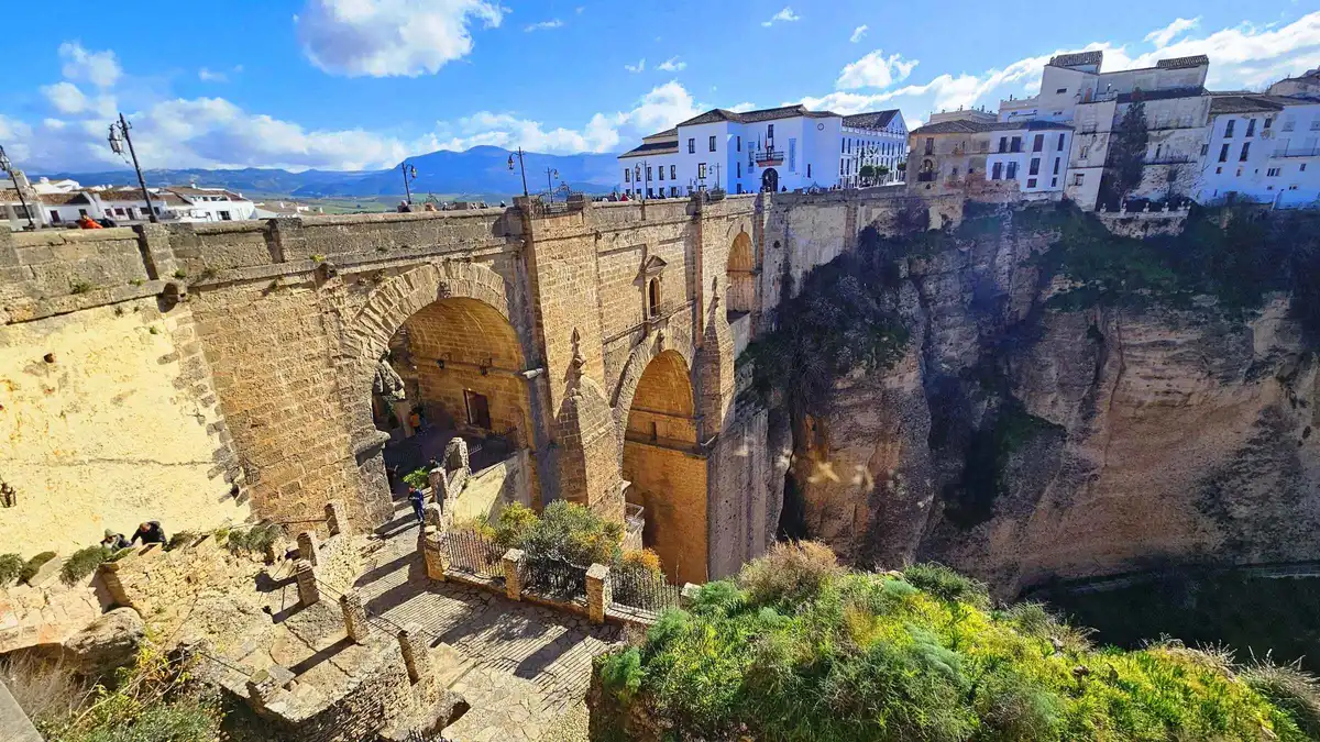 Tourist train climbing to the centre of Setenil de las Bodegas on a coach trip from Malaga