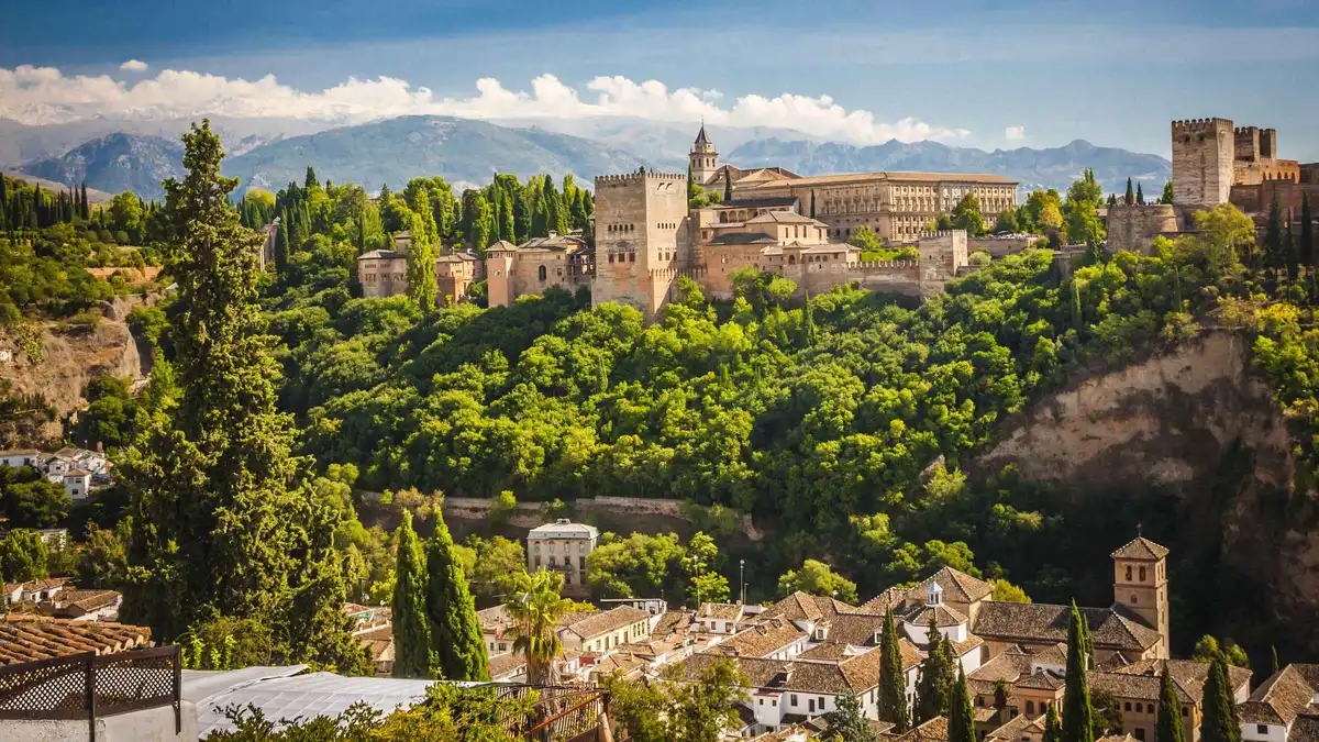 Alhambra palace walls above Granada seen from the Alcazaba towers on a bus day trip from Malaga