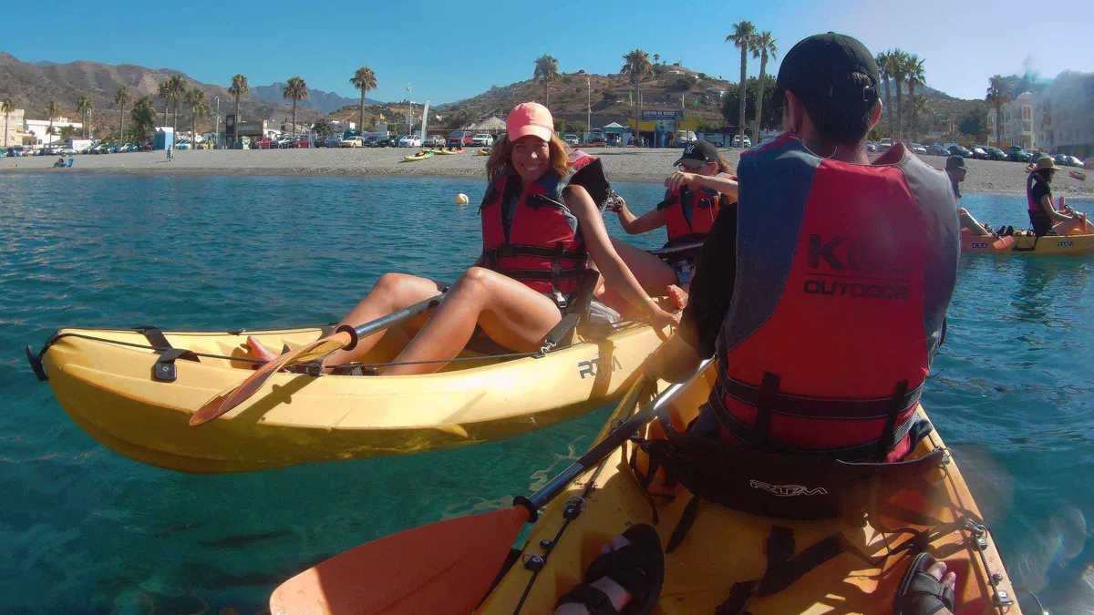 Kayakers paddling beneath the Maro-Cerro Gordo cliffs on a guided kayaking tour from Málaga