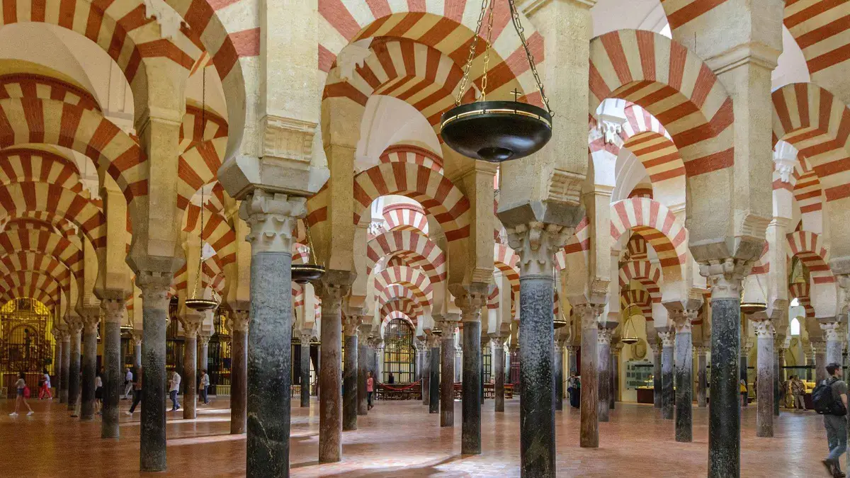 Guided group in the Patio de los Naranjos of the Mosque-Cathedral on a Córdoba day trip from Málaga